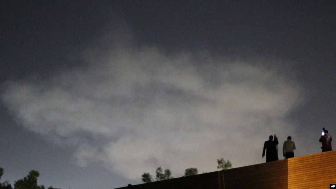 A plume of smoke rises in a sky after an air strike in Tripoli on May 27, when Group of Eight countries increased public pressure on Libyan leader Muammar Qaddafi to step down.