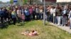 Residents of Temirtau rally near the site where 2-year-old Yegor Khmil fell through an uncovered manhole and drowned.