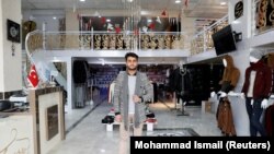 FILE: Owner of a luxury clothes shop Sohail Ataie, 22, poses for a picture in Kabul in January.