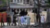 Pakistani security officials inspect the scene of a deadly bomb in Lahore that killed three people and wounded dozens. 