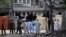 Pakistani security officials inspect the scene of a deadly bomb in Lahore that killed three people and wounded dozens. 