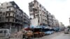 Syria -- Stalls are seen on a street beside damaged buildings in the rebel held al-Shaar neighborhood of Aleppo, February 10, 2016