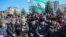 Local people hold Ingushetian flags as they attend a rally to protest against a controversial border deal with neighboring Chechnya in Magas on March 26, 2019.