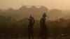 Pakistani nomad women carry water to their houses in a hazy evening on the outskirts of Islamabad. (file photo)