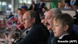 Russian President Vladimir Putin (left) and Belarusian leader Alyaksandr Lukashenka (center) with his son Mikalay watch the gold-medal game of Russia vs Finland at the IIHF International Ice Hockey World Championship in Minsk in May 2014.