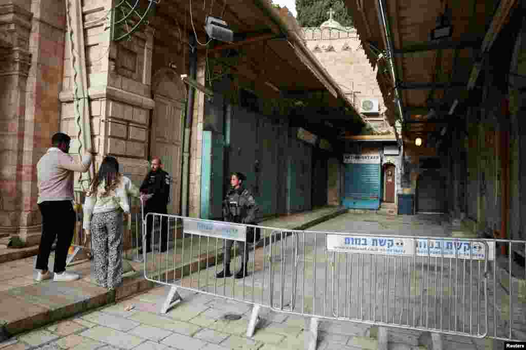 Christian worshippers are stopped by Israeli security officers outside the Church of the Holy Sepulchre in Jerusalem after being blocked from attending Easter Monday events on April 5. Restrictions were placed on large gatherings amid the conflict with Iran.