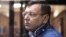 The director of the Listvyazhnaya coal mine, Sergei Makhrakov, seen inside a defendant's cage in a courtroom in Kemerovo on November 27, is accused of violating industrial safety rules that led to the deaths of the miners.