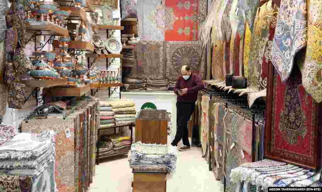 An Iranian shopkeeper waits for customers in his booth at the Tajrish bazaar in Tehran.