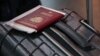  A passport and a suitcase are pictured at Vnukovo International Airport.