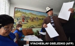 A voter casts his ballot during Kyrgyzstan's parliamentary elections in the village of Gornaya-Mayevka outside Bishkek on November 28.