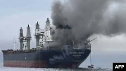 A photo released by the Royal Thai Navy shows smoke rising from the Thai-flagged bulk carrier Mayuree Naree near the Strait of Hormuz after an attack on March 11.