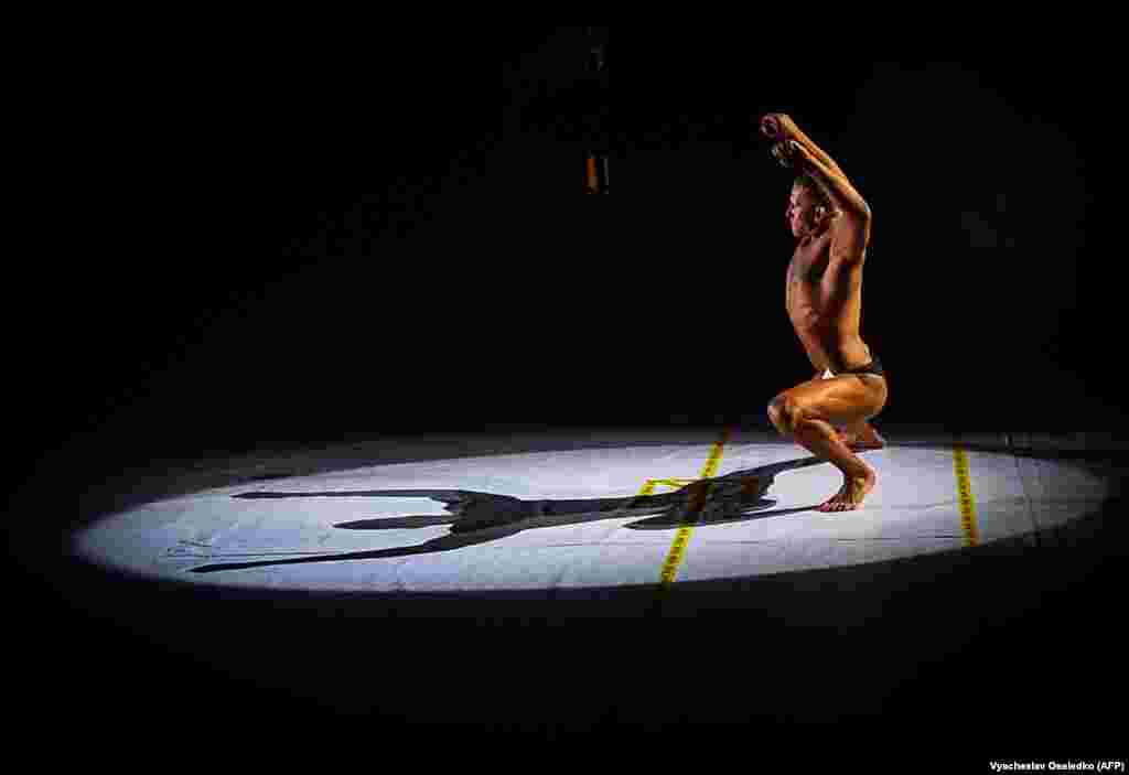 A bodybuilder performs during a competition in Bishkek. (AFP/Vyacheslav Oseledko)