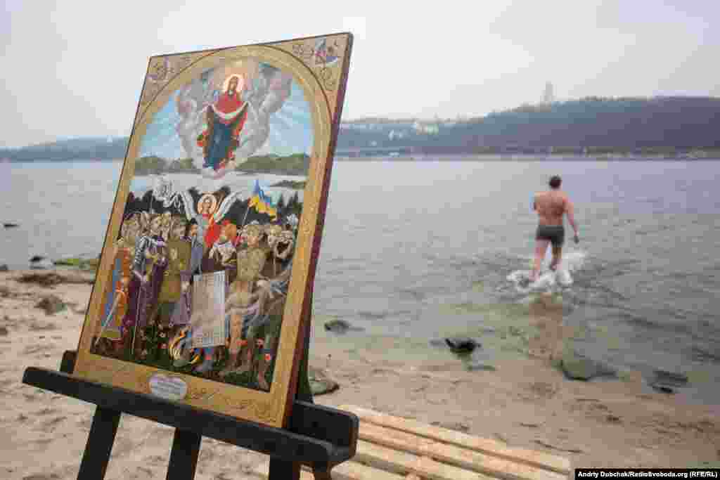 A believer wades into the cold waters of the Dnieper River.