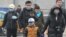 China -- People wear masks walking in the street while the PM2.5 Air Quality Index (AQI) reaches more than 500 in Beijing city, 15 January 2015. 