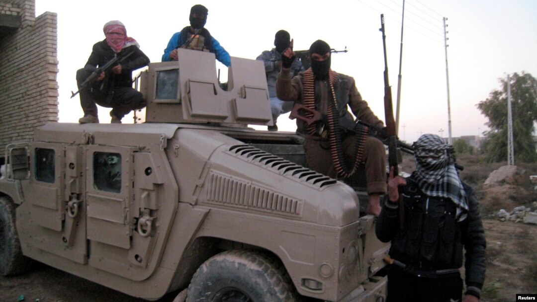 Sunni gunmen sit on top of an Iraqi Army vehicle left by Iraqi soldiers during clashes in the city of Fallujah on January 9.