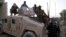 Sunni gunmen sit on top of an Iraqi Army vehicle left by Iraqi soldiers during clashes in the city of Fallujah on January 9.