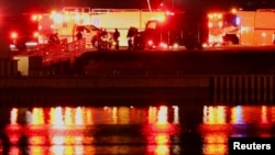 Rescue personnel swarm the banks of the Potomac River after American Eagle flight 5342 crashed near Ronald Reagan Washington National Airport late on January 29.