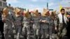 Members of Iranian Basij paramilitary force reenact the January capture of U.S sailors by the Revolutionary Guards in the Persian Gulf, in a rally commemorating the 37th anniversary of Islamic Revolution in Tehran, Feb. 11, 2016. 