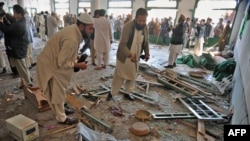 Security personnel investigate the bomb blast site in Nowshera