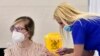 MONTENEGRO -- A medical worker gives a shot of Chinese Sinopharm COVID-19 vaccine to a woman during the vaccination in Podgorica, May 4, 2021