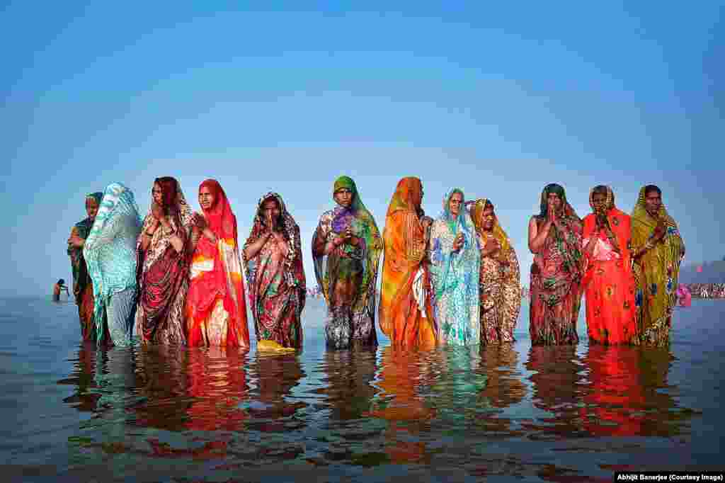 Photographer Abhijit Banerjee of India: Gangasagar Fair &nbsp; Gangasagar Fair is the second-largest fair in India and the largest in West Bengal and celebrates the harvest. I captured a group of women devotees who had come from Uttar Pradesh state while they worshipped the sun just after their holy dip.