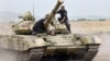 Nagorno-Karabakh - Armenian Prime Minister Tigran Sarkisian drives a tank near Karabakh Armenian frontline positions, 02Aug2011.