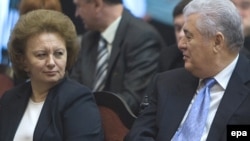 Communist leader Vladimir Voronin (right) speaks to former Prime Minister Zinaida Grecianii before a presidential vote in Chisinau on December 7.