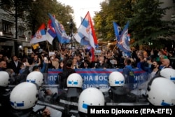 Serbian police officers guard a street.