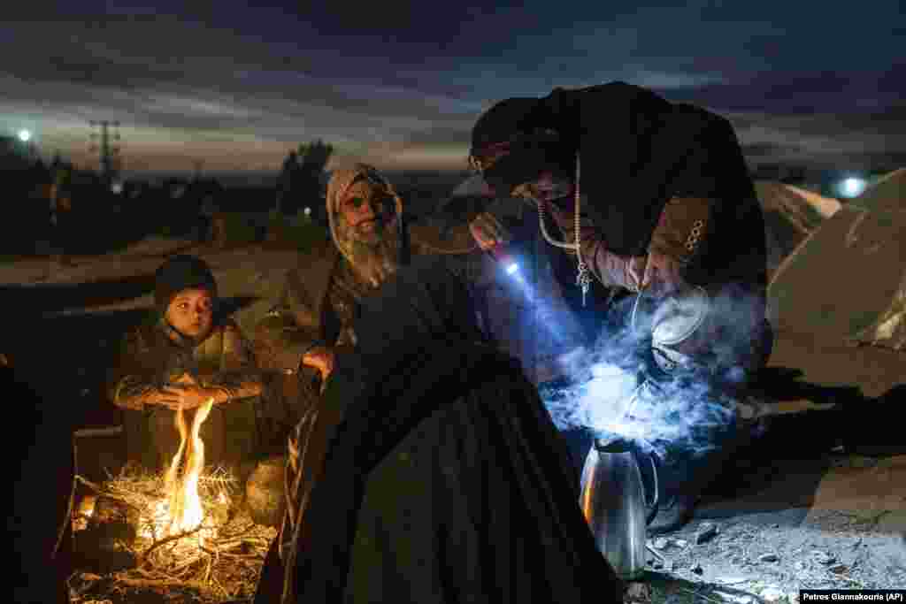 A family prepares tea in their camp outside an aid office in Herat, Afghanistan. About 2,000 internally displaced people left the village of Allahyar in Ghor Province because of a drought and are seeking help from the regional government in Herat.