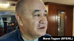 Omurbek Tekebaev is seen shortly after the attack, with visible injuries on his face. 