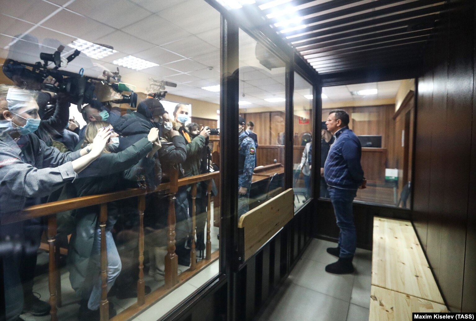 The director of the Listvyazhnaya coal mine, Sergei Makhrakov, seen inside a defendant's cage in a courtroom in Kemerovo, is accused of violating industrial safety rules that led to the deaths of the miners.