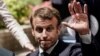 France's President Emmanuel Macron gestures as he leaves a press conference at the end of an EU summit at the Europa building in Brussels, on July 1, 2019