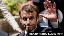 France's President Emmanuel Macron gestures as he leaves a press conference at the end of an EU summit at the Europa building in Brussels, on July 1, 2019