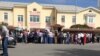 People wait outside the Russian Embassy in Ashgabat, waiting to apply for travel or work documents, in May 2019.