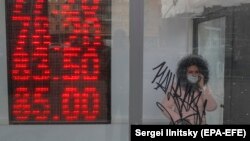 A woman leaves an exchange office in Moscow on March 20.