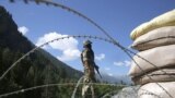 INDIA -- An Indian paramilitary soldier stands guard at check post along a highway leading to Ladakh, at Gagangeer some 81 kilometers from Srinagar, the summer capital of Indian Kashmir, 17 June 2020. 