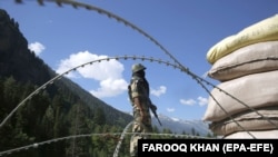 An Indian paramilitary soldier stands guard at a check post along a highway leading to Ladakh, some 81 kilometers from Srinagar, the summer capital of Indian Kashmir, on June 17. 