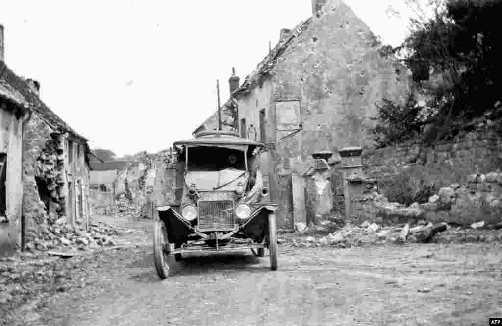 An American Ford ambulance is parked in a devasted village in Belgium in September 1918.