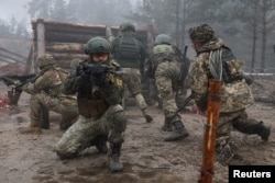 Ukrainian soldiers take part in a military drill on psychological combat training