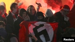 Fans demonstrate as they hold up a Nazi flag in the stands of the Spartak Moscow supporters during the Russian Cup match between Shinnik Yaroslavl and Spartak Moscow in Yaroslavl on October 30.