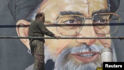 Ready for a makeover? An worker rests in front of a huge portrait of Supreme Leader Ayatollah Ali Khamenei on a wall near a Tehran university in late February.