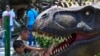 Children enjoy replicas of dinosaurs in the newly opened Dino Park in the zoo in Skopje, North Macedonia.