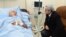 Armenian President Serzh Sarkisian visits wounded opposition presidential candidate Paruyr Hairikian at a Yerevan hospital.
