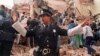 An Argentinian policeman prevents people from approaching the site where a powerful explosion destroyed the seven-story building housing the Jewish Mutual Association of Argentina in Buenos Aires in July 1994.