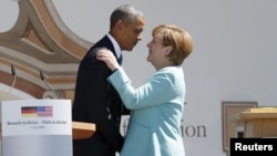 U.S. President Barack Obama (left) and German Chancellor Angela Merkel embrace after delivering remarks in the Bavarian village of Krun on June 7. 