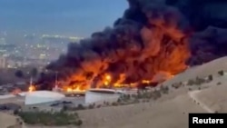 Flames and smoke rise from the Shahran oil depot in Tehran.