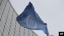 The flag of the International Atomic Energy Agency flies in front of its headquarters during an IAEA Board of Governors meeting in Vienna, Austria, Feburary 2023