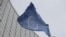 The flag of the International Atomic Energy Agency flies in front of its headquarters during an IAEA Board of Governors meeting in Vienna, Austria, Feburary 2023