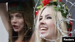 Femen activists demonstrate in front of the headquarters of the International Ice Hockey Federation in Zurich in February. They were trying to draw attention to the political situation in Belarus ahead of that country's hosting of the Hockey World Cup in 2014.