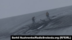 Workers assess the damage in February 2025 after a drone hit the dome encapsulating the stricken Chernobyl nuclear power plant in Ukraine.